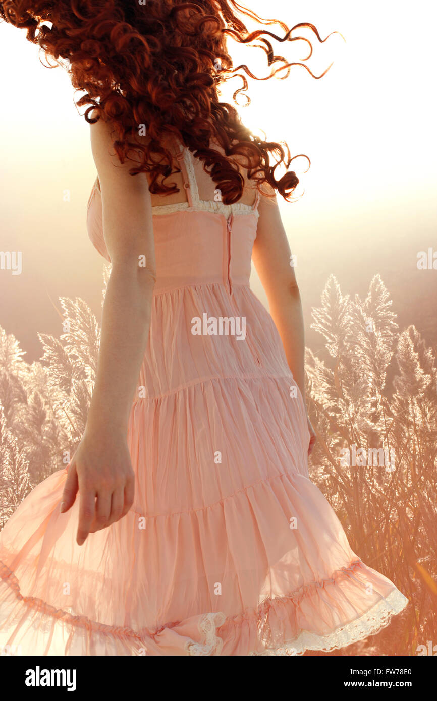 Curly woman turning away Stock Photo