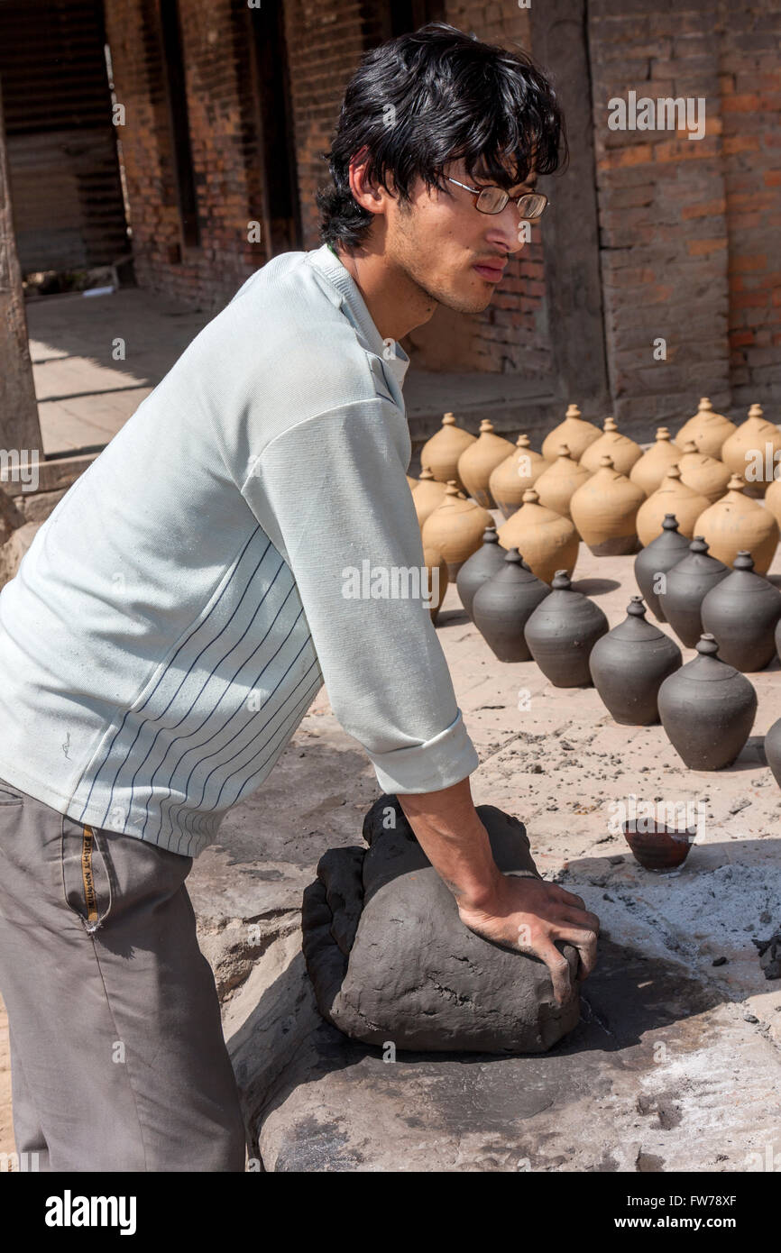 Bhaktapur, Nepal. Young Potter Kneading Clay in Potters' Square Stock