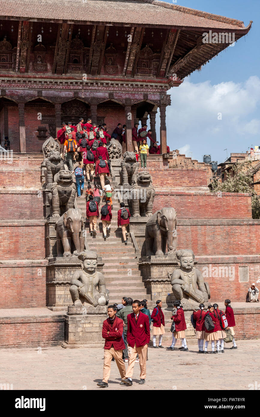 Bhaktapur, Nepal.  Nepalese Students in Uniform Visiting the Nyatapola Temple.  Guardians Line the Steps. Stock Photo