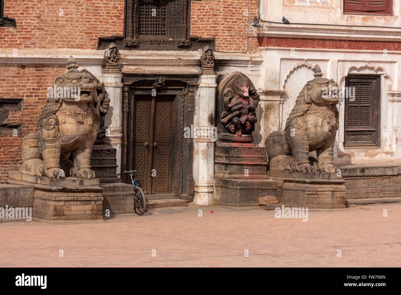 Bhaktapur, Nepal.  Lions Guarding Entrance to Palace, Durbar Square. Stock Photo
