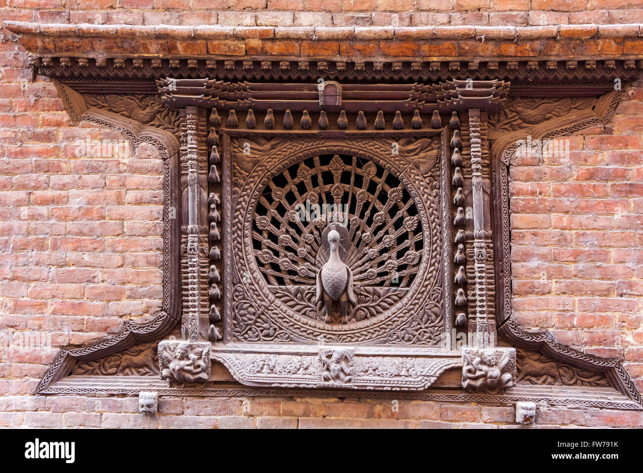 Bhaktapur, Nepal.  The Peacock Window, in Pujari Math.  Building was heavily damaged in 2015 earthquake but the window survived. Stock Photo