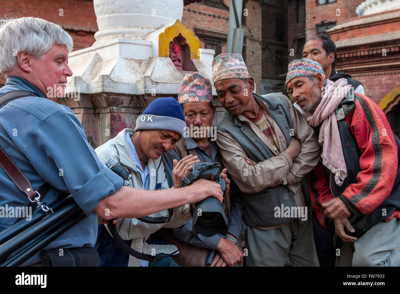 Bhaktapur, Nepal.  Tourist Showing Newari Men their Photo on Camera Screen. Stock Photo