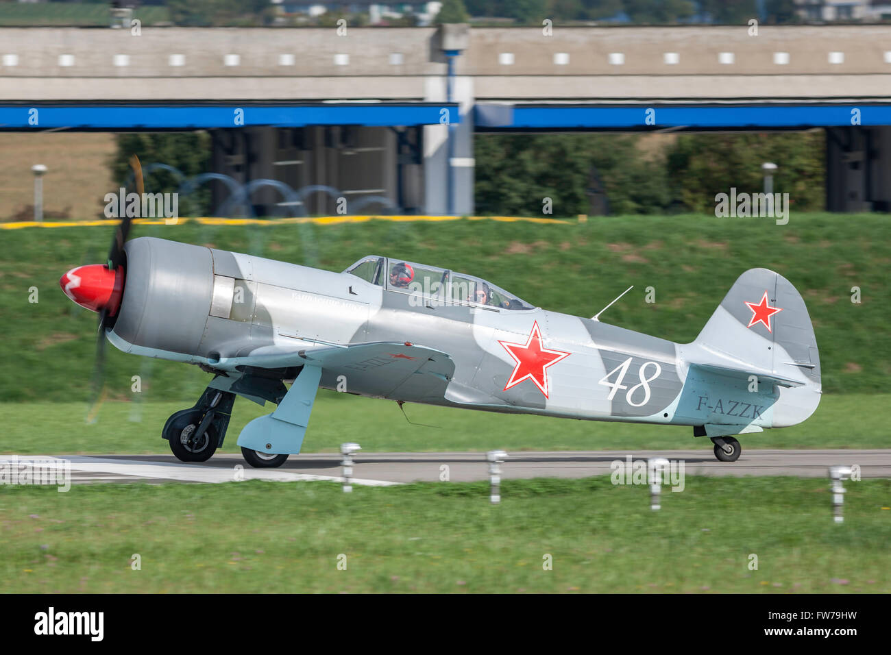 Yakovlev Yak-3UWP F-AZZK taking off with vortices forming around the aircraft from the tips of the propeller. Stock Photo
