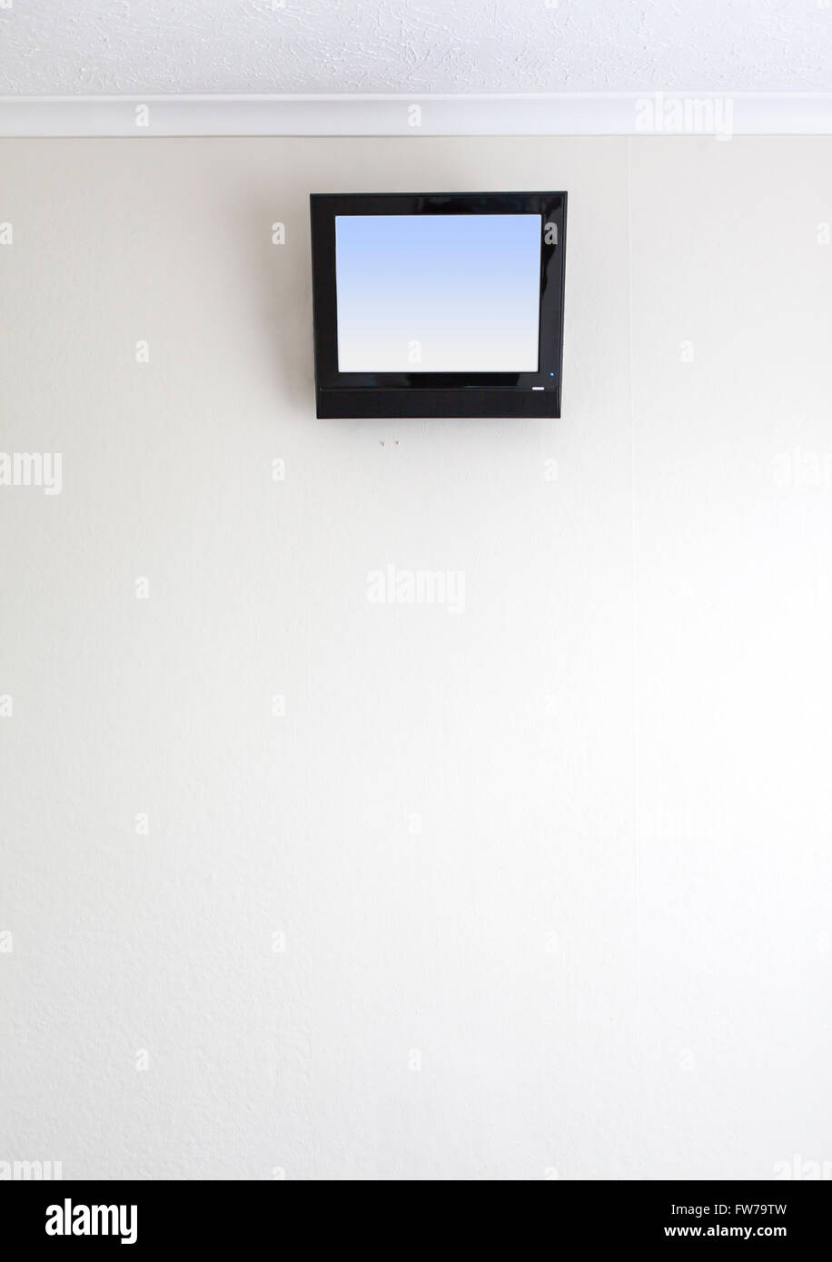 small TV on motel wall Stock Photo