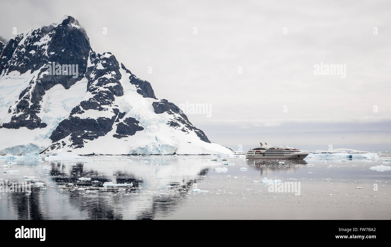A small cruise ship Le Lyrial in the Neumayer Channel of Antarctica. Stock Photo