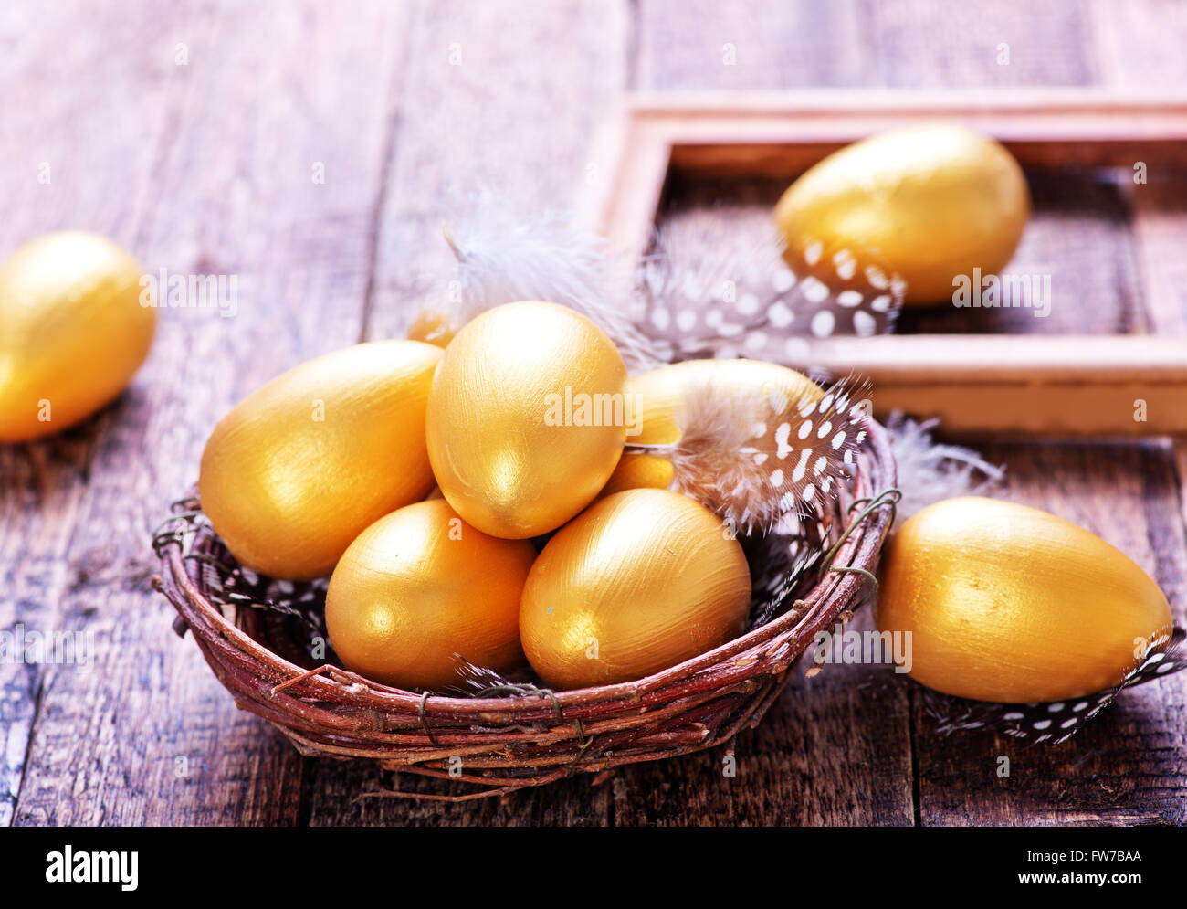 golden eggs in nest and on a table Stock Photo - Alamy