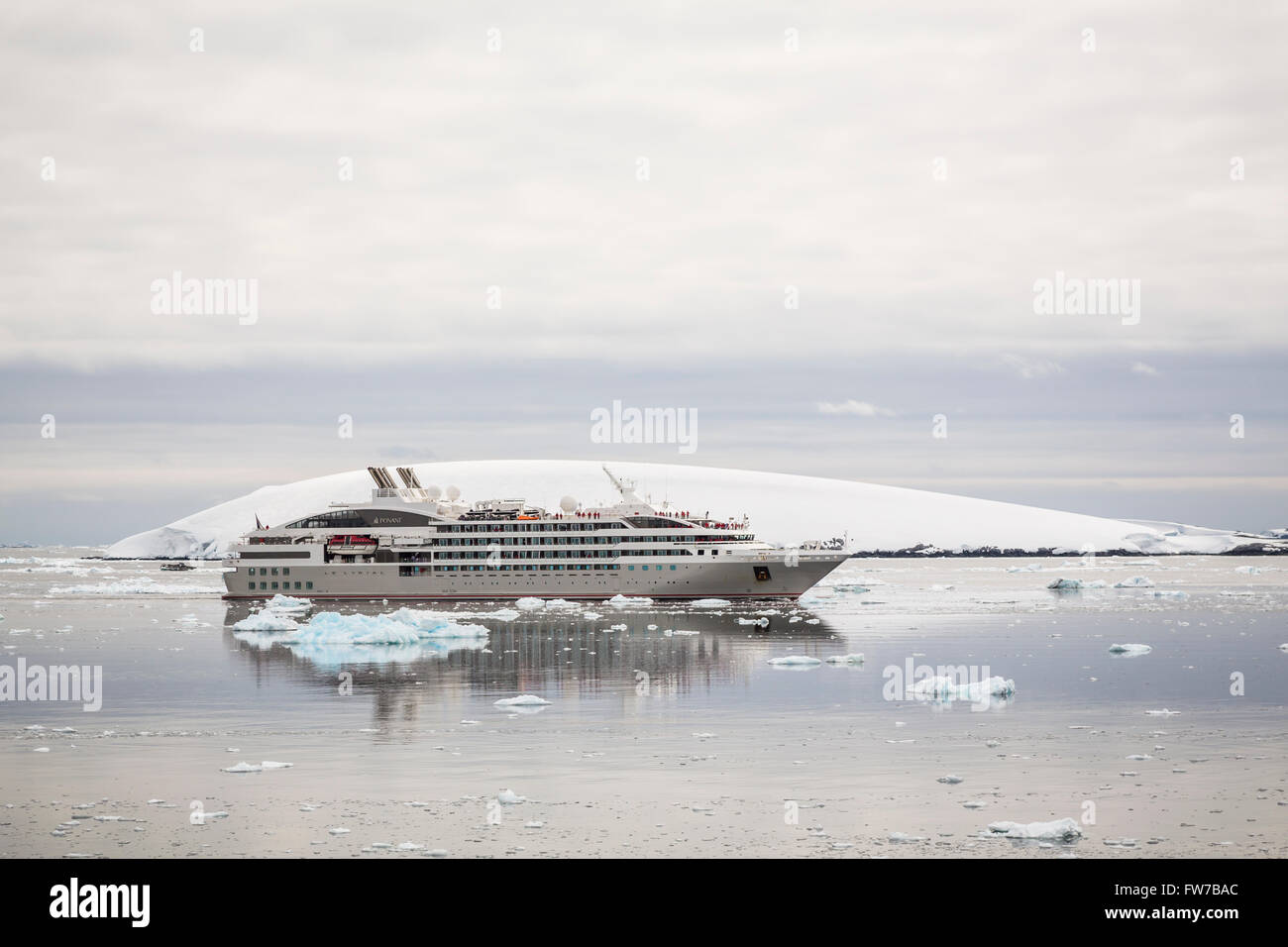 A small cruise ship Le Lyrial in the Neumayer Channel of Antarctica. Stock Photo