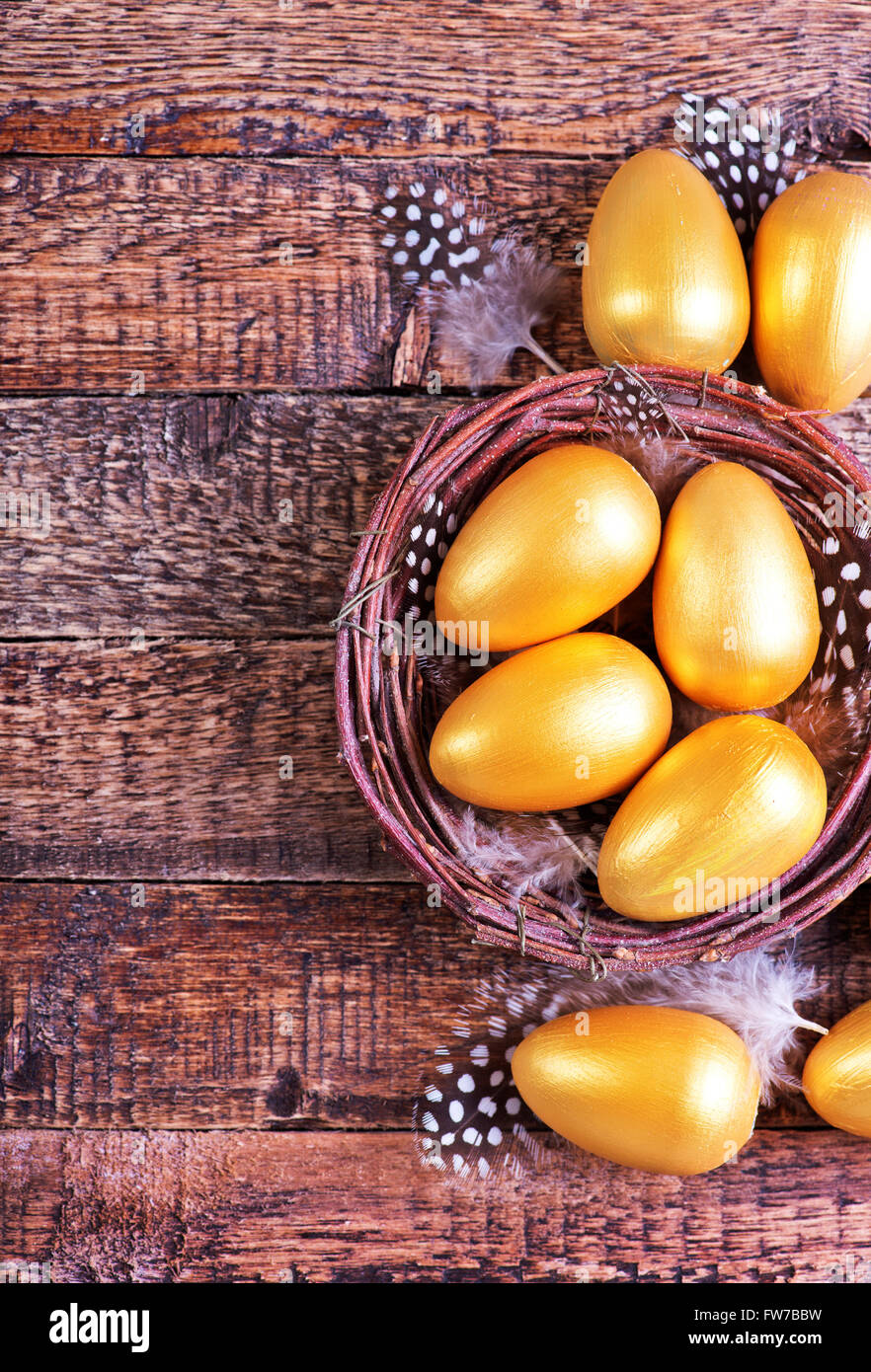golden eggs in nest and on a table Stock Photo - Alamy