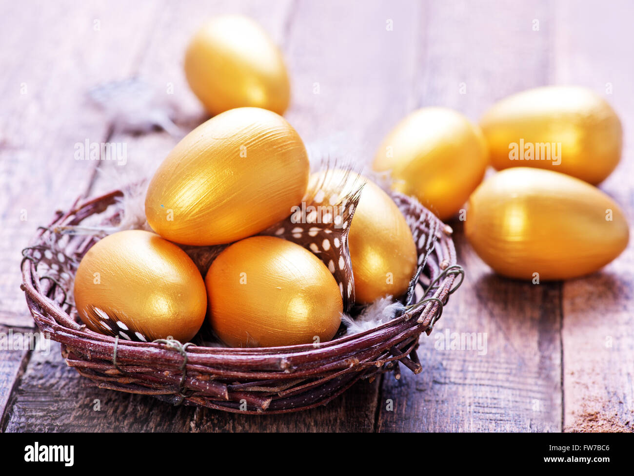 golden eggs in nest and on a table Stock Photo - Alamy