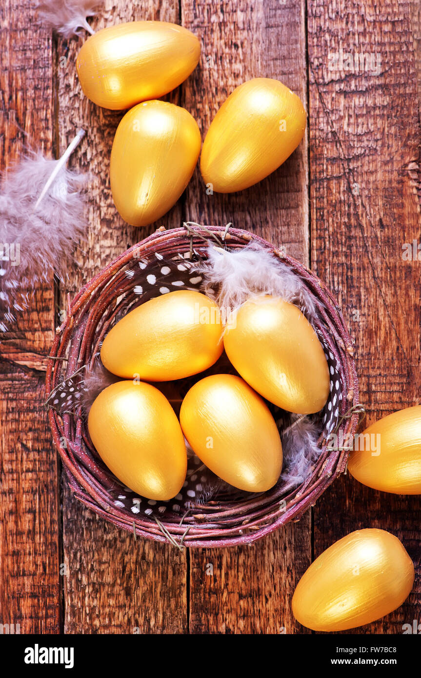 golden eggs in nest and on a table Stock Photo - Alamy