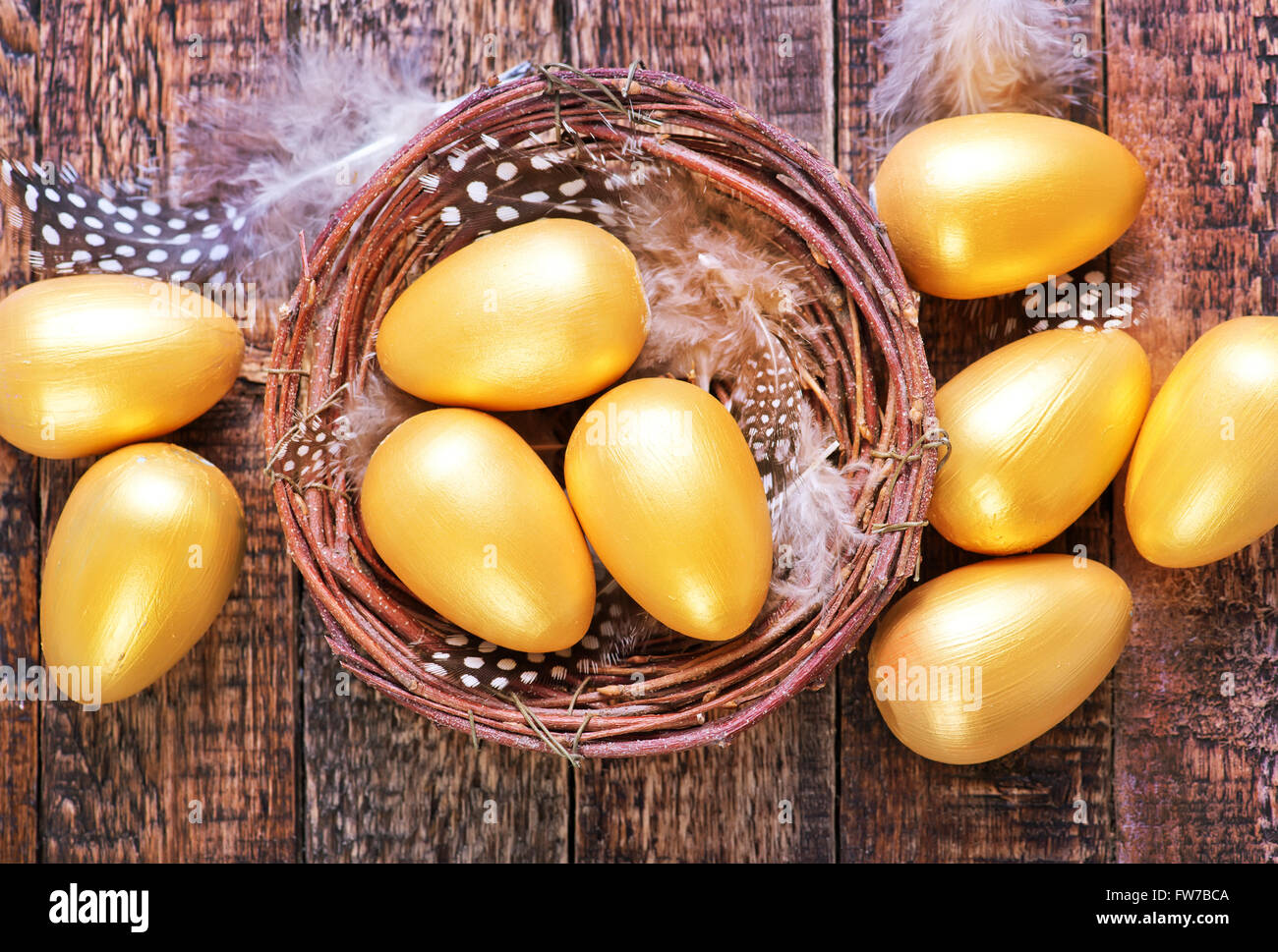 golden eggs in nest and on a table Stock Photo - Alamy