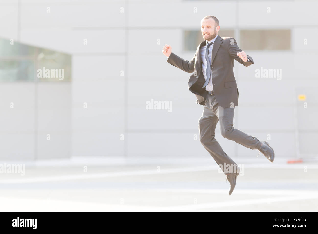 Dynamic businessman jumping outdoor in the city Stock Photo