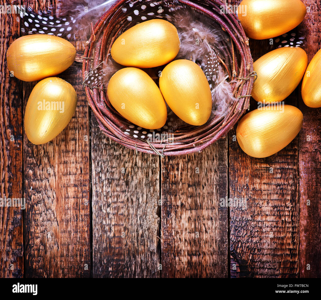 golden eggs in nest and on a table Stock Photo - Alamy