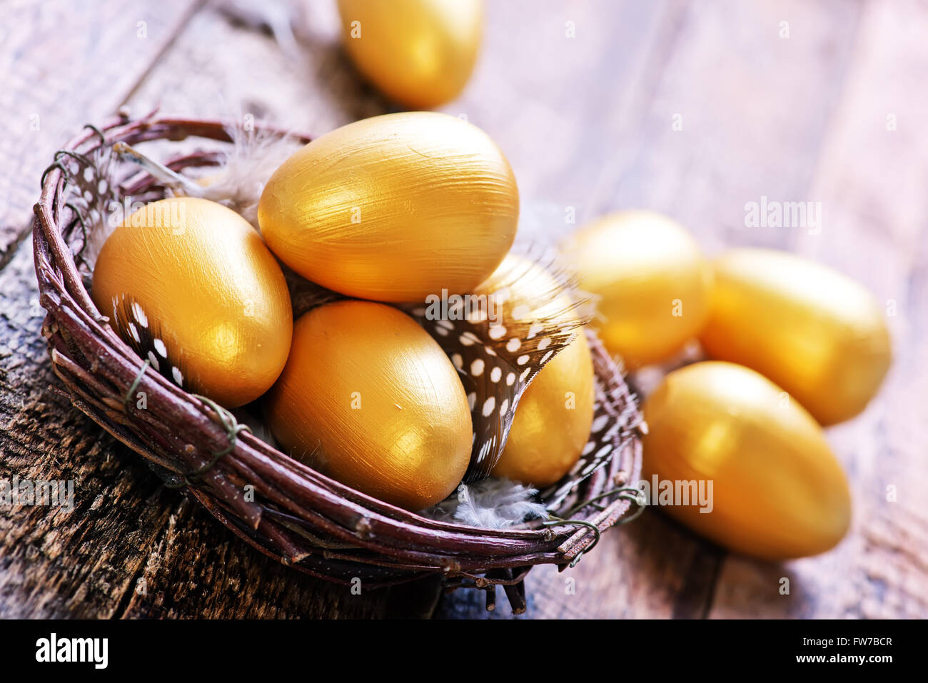 golden eggs in nest and on a table Stock Photo - Alamy