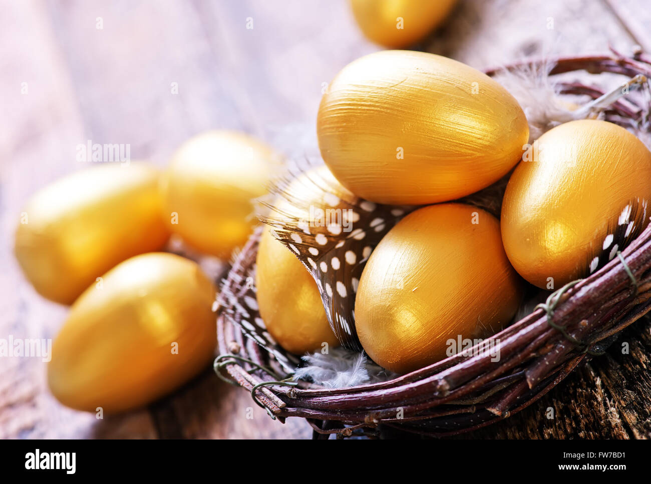 golden eggs in nest and on a table Stock Photo - Alamy