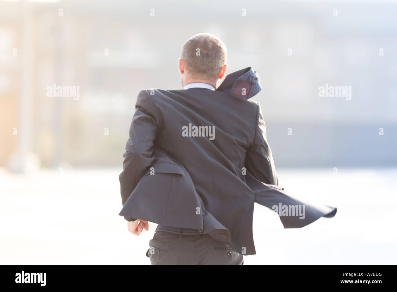 Happy businessman running outdoor in the city Stock Photo