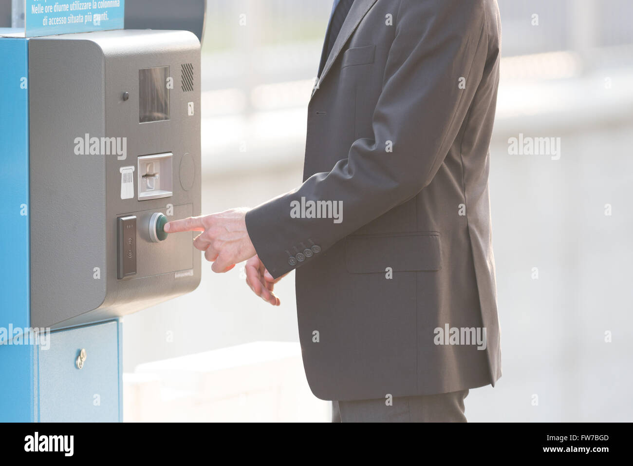 Businessman and a parking ticket pay machine, modern life concepts Stock Photo