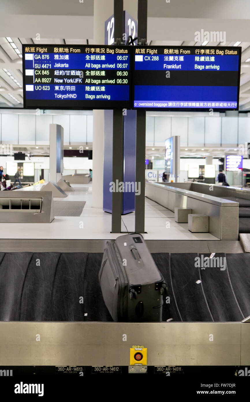 luggage on the conveyor under bags arrival schedule at airport terminal Stock Photo