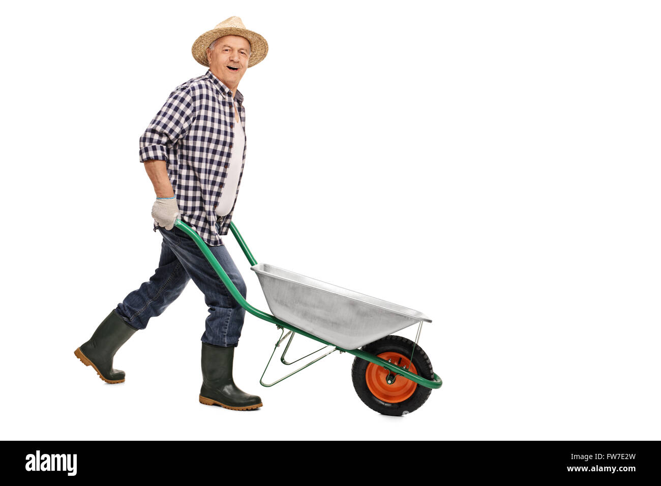 Mature gardener pushing an empty wheelbarrow and looking at the camera isolated on white background Stock Photo