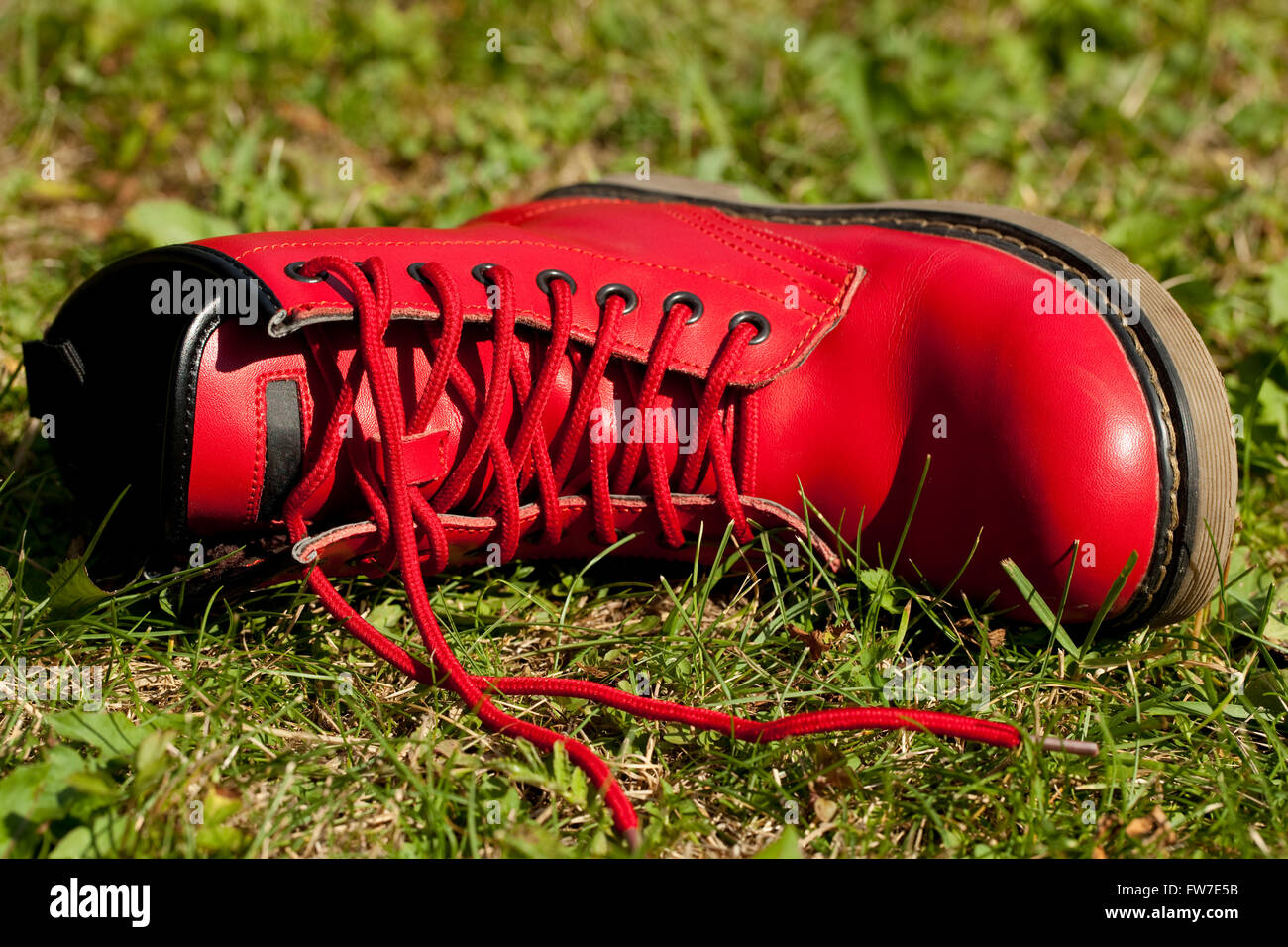 red leather shoe lies on grass Stock Photo