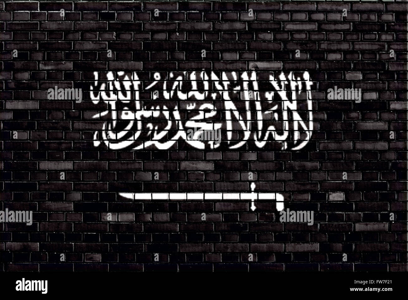 Black flag of Jihad painted on brick wall Stock Photo