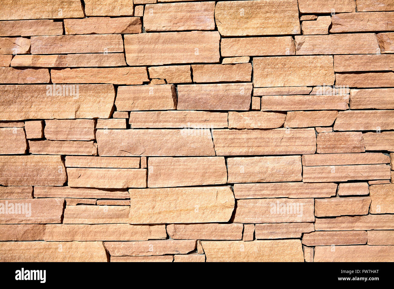 stone natural rock veneer wall and building finish design and pattern closeup for construction industry and manufacturing Stock Photo