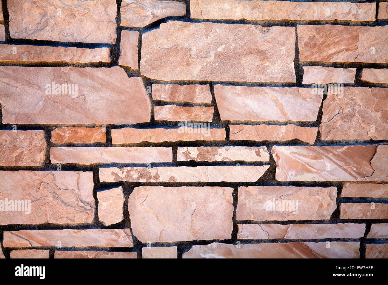 stone natural rock veneer wall and building finish design and pattern closeup for construction industry and manufacturing Stock Photo