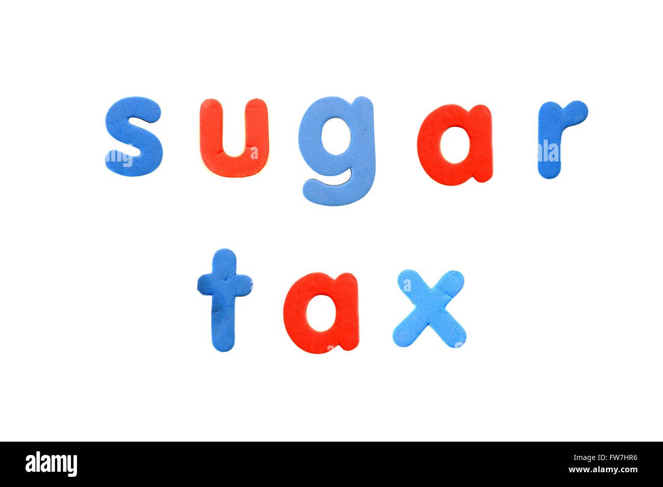 The words Sugar Tax created from magnetic fridge alphabet pieces photographed against a white background. Stock Photo