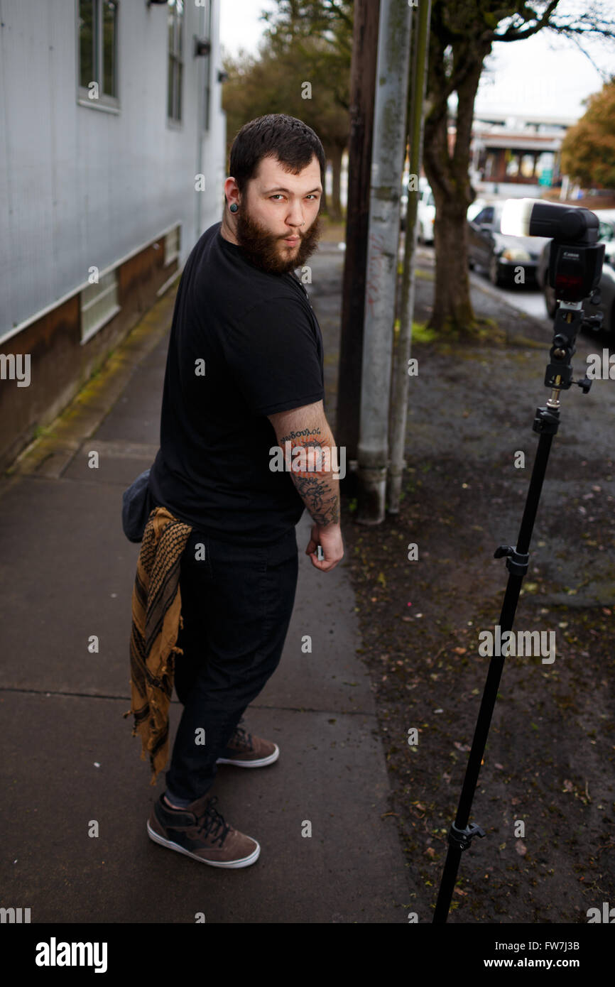 EUGENE, OR - MARCH 20, 2016: Urban portrait of a bearded hipster man with tattoos. Stock Photo