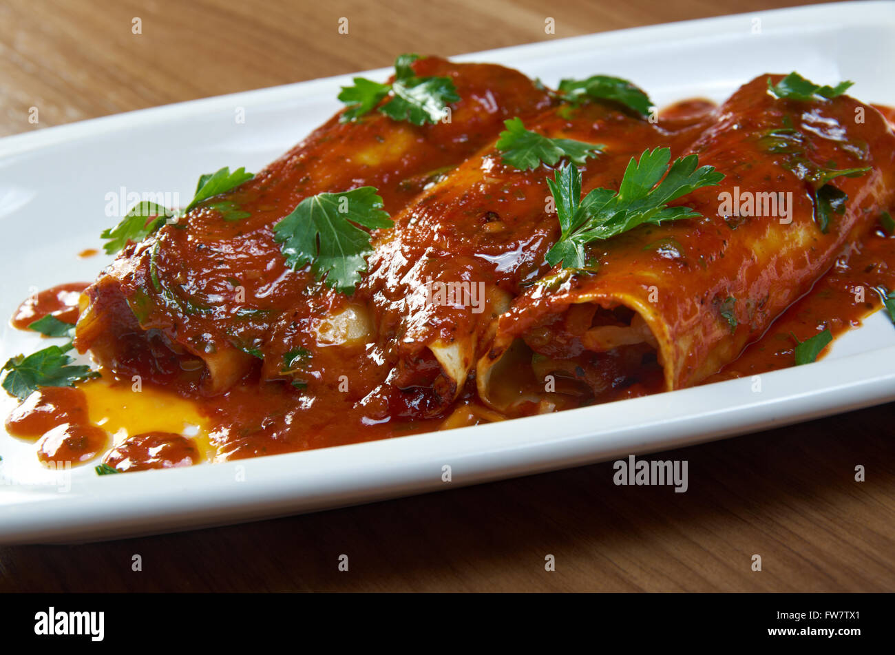 Southwest beef enchilada  . corn tortilla rolled around a filling and covered with a chili pepper sauce Stock Photo