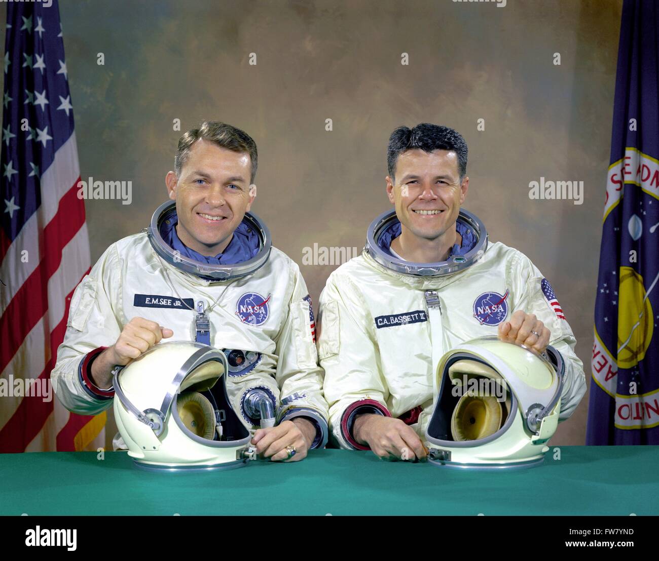 The original Gemini 9 space mission prime crew members Commander, Elliot M. See Jr., left, and pilot Charles A. Bassett II, in their spacesuits at the Johnson Space Center January 5, 1966 in Houston, Texas. The back-up crew became the prime crew when on February 28, 1966, the original prime crew was killed when their twin seat T- 38 trainer jet aircraft crashed into a building during a landing approach in bad weather. Stock Photo