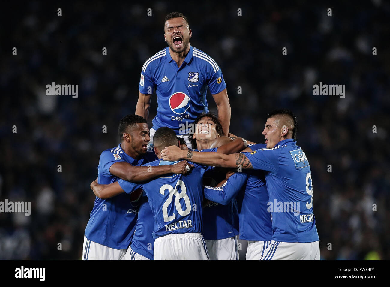 Bogota, Colombia. 31st Mar, 2016. Millonarios' players celebrate scoring during the postponed match of the Aguila League of Colombian professional soccer, against Atletico Nacional, at Nemesio Camacho 'El Campin' stadium, in Bogota city, Colombia, on March 31, 2016. Millonarios won 2-1. © Jhon Paz/Xinhua/Alamy Live News Stock Photo