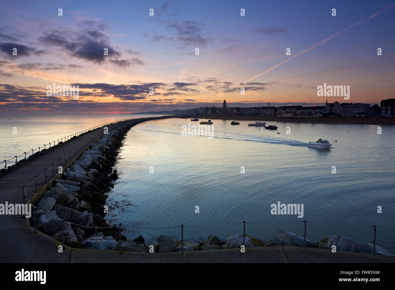 Herne Bay, Kent, UK. 1st April 2016: UK Weather. Pre dawn glow as the rain clouds disappear over Herne bay marina as a boat heads out to sea, ahead of a weekend of temperatures up to 16C in the south east Credit:  Alan Payton/Alamy Live News Stock Photo