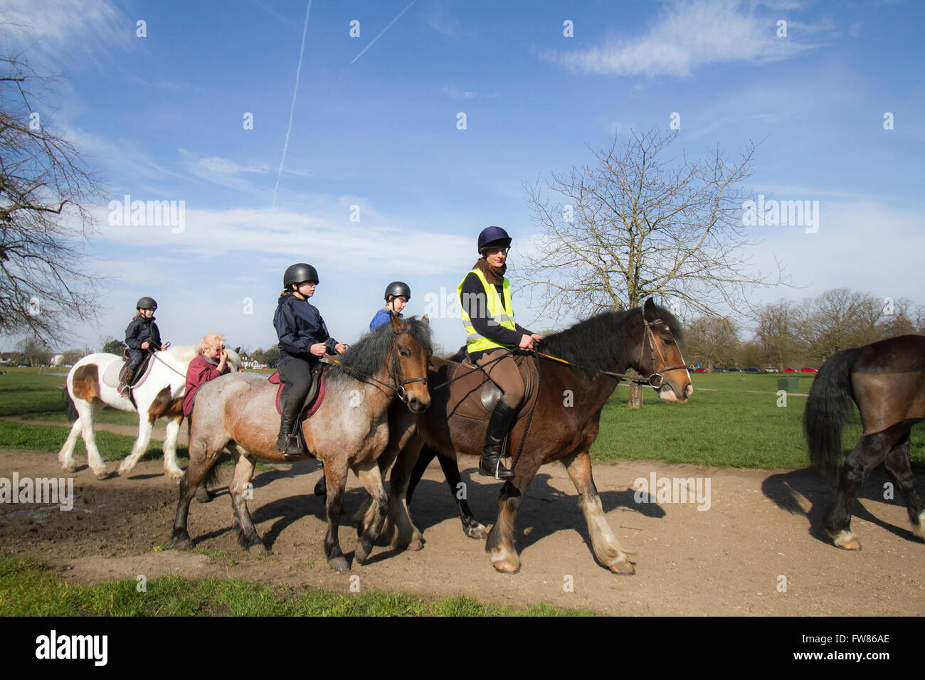 Wimbledon London, UK. 1st April 2016. UK Weather: A group of horse riders form a riding school enjoy the spring sunshine on Wimbledon Common as temperatures are forecast to rise Credit:  amer ghazzal/Alamy Live News Stock Photo