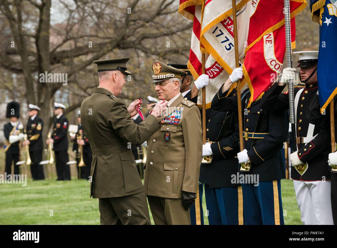 U.S Joint Chiefs Chairman General Joseph F. Dunford Jr. presents the Legion of Merit to Chief of Defense for Italian Armed Forces General Claudio Graziano during a full honors ceremony at Whipple Field on Joint Base Myer-Henderson Hall March 31, 2016 in Arlington, Virginia. Stock Photo