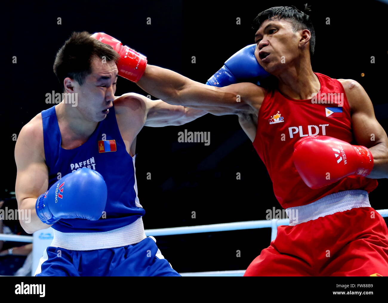 Qian'an, China's Hebei Province. 1st Apr, 2016. Tuvshinbat Byamba (L) of Mongolia competes against Shakhobidin Eumir Felix Delos Santos Marcial of Philippines during the bronze medal match of the men's 69kg category competition at the Asia/Oceania Zone boxing event qualifier for 2016 Rio Olympic Games in Qian'an, north China's Hebei Province, April 1, 2016. Credit:  Yang Shiyao/Xinhua/Alamy Live News Stock Photo