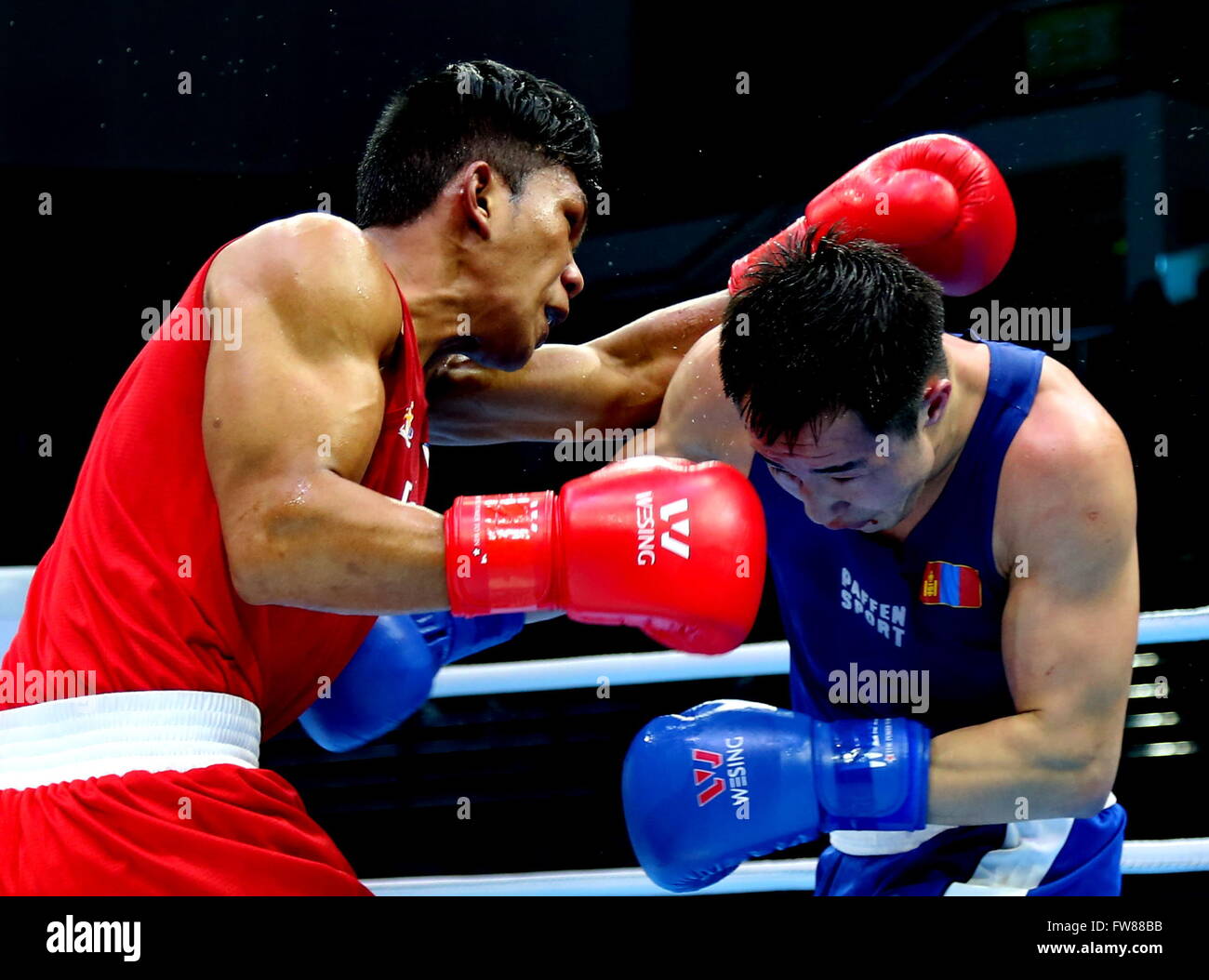 Qian'an, China's Hebei Province. 1st Apr, 2016. Tuvshinbat Byamba (R) of Mongolia competes against Shakhobidin Eumir Felix Delos Santos Marcial of Philippines during the bronze medal match of the men's 69kg category competition at the Asia/Oceania Zone boxing event qualifier for 2016 Rio Olympic Games in Qian'an, north China's Hebei Province, April 1, 2016. Credit:  Yang Shiyao/Xinhua/Alamy Live News Stock Photo