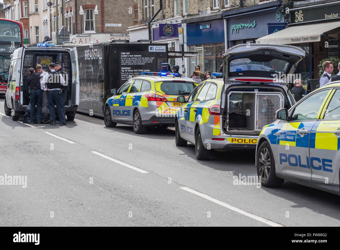 Clapham, London, UK. 01st Apr, 2016. A man is arrested by police for allegedly stealing a bag on Northcote Road, Clapham, SW London. He was initially chased and brought to the ground by a manager from The Byron Burger restaurant and then four police cars (incl one with a dog) and a police van arrived. It must have been a quiet morning for the police as twenty minutes earlier eight plain clothes officers were having a drink break in the Starbucks, 50 yards away from the incident - albeit they were not involved in the arrest. Credit:  Guy Bell/Alamy Live News Stock Photo