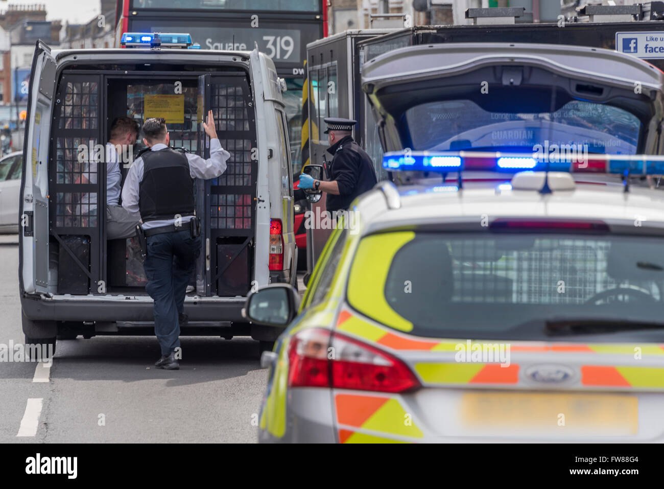 Clapham, London, UK. 01st Apr, 2016. A man is arrested by police for allegedly stealing a bag on Northcote Road, Clapham, SW London. He was initially chased and brought to the ground by a manager from The Byron Burger restaurant and then four police cars (incl one with a dog) and a police van arrived. It must have been a quiet morning for the police as twenty minutes earlier eight plain clothes officers were having a drink break in the Starbucks, 50 yards away from the incident - albeit they were not involved in the arrest. Credit:  Guy Bell/Alamy Live News Stock Photo