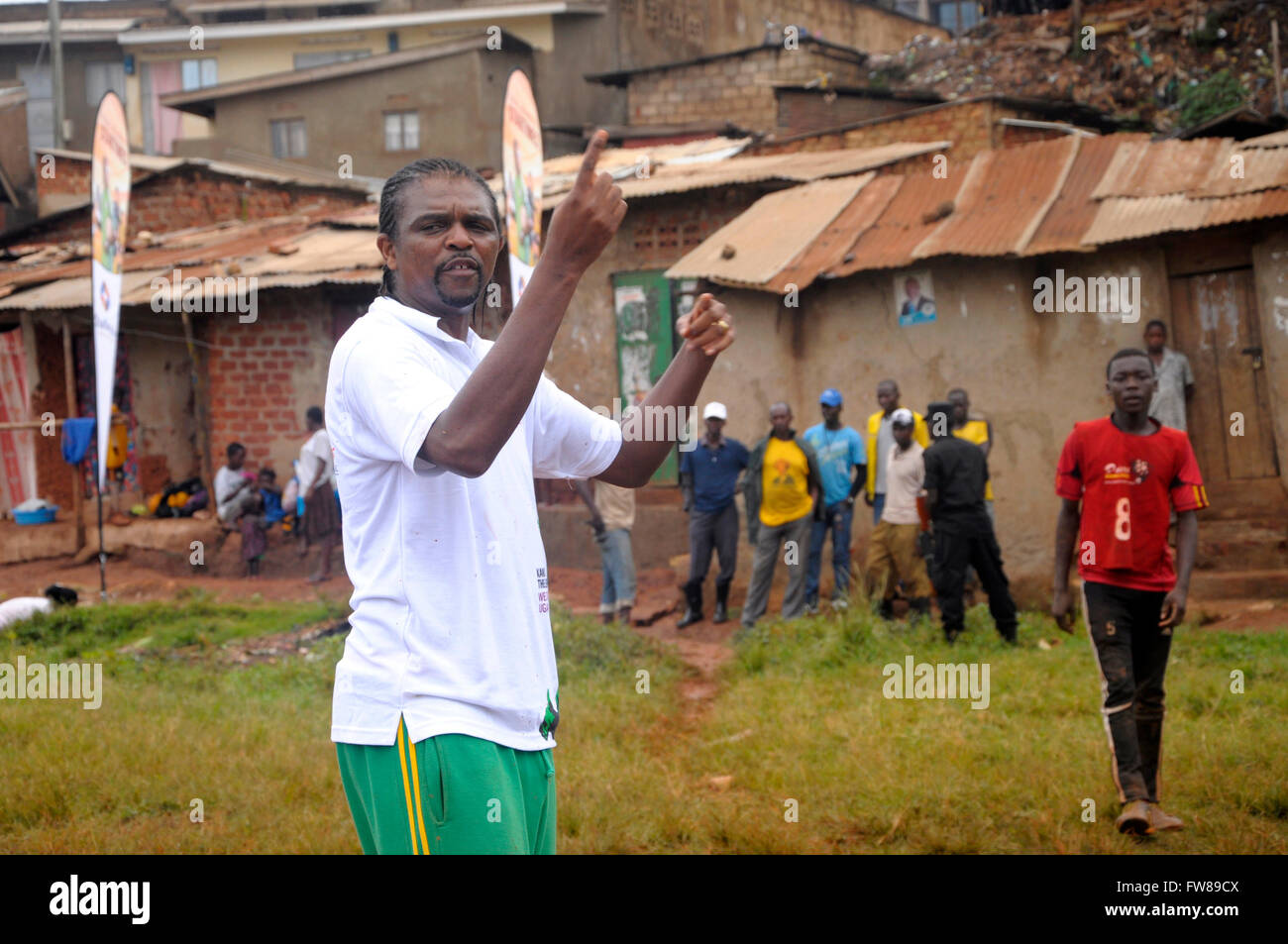 Kampala, Uganda. 01st Apr, 2016. Former Arsenal FC striker and Nigerian international Nwankwo Kanu gives tips to budding football players in a slum in the Ugandan capital Kampala. Kanu was in a working visit to the East African country as an ambassador of Chinese pay TV StarTimes. Credit:  Samson Opus/Alamy Live News Stock Photo