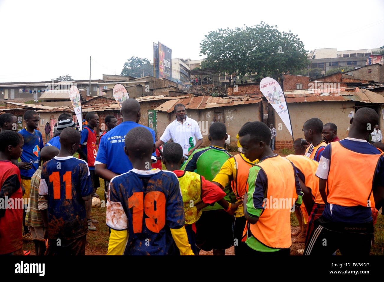 Kampala, Uganda. 01st Apr, 2016. Former Arsenal FC striker and Nigerian star Nwankwo Kanu gives tips to budding football players in a slum in the Ugandan capital Kampala. Kanu was in a working visit to the East African country as an ambassador of Chinese pay TV StarTimes. Credit:  Samson Opus/Alamy Live News Stock Photo