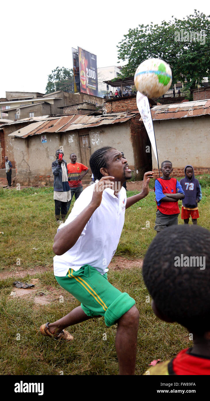 Kampala, Uganda. 01st Apr, 2016. Former Arsenal FC striker and Nigerian international Nwankwo Kanu gives tips to budding football players in a slum in the Ugandan capital city Kampala. Kanu was in a working visit to the East African country as an ambassador of Chinese pay TV StarTimes. Credit:  Samson Opus/Alamy Live News Stock Photo
