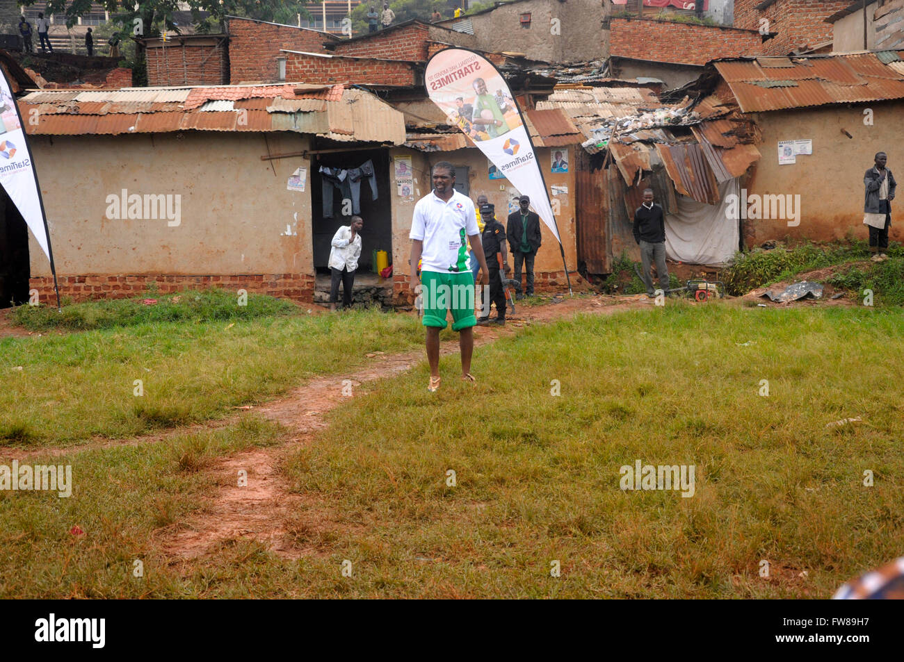 Kampala, Uganda. 01st Apr, 2016. Former Arsenal FC striker and Nigerian international Nwankwo Kanu watches budding football players playing in a slum in the Ugandan capital city, Kampala. Kanu was in a working visit to the East African country as an ambassador of Chinese pay TV StarTimes. Credit:  Samson Opus/Alamy Live News Stock Photo