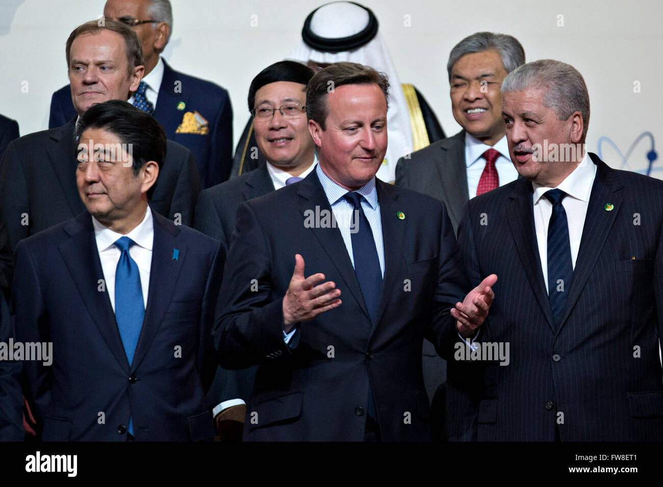 David Cameron, U.K. prime minister, center, talks to Abdelmalek Sellal, Algeria's prime minister, during a family photo with Shinzo Abe, Japan's prime minister, left, at the Nuclear Security Summit in Washington, DC, U.S., on Friday, April 1, 2016. After a spate of terrorist attacks from Europe to Africa, U.S. President Barack Obama is rallying international support during the summit for an effort to keep Islamic State and similar groups from obtaining nuclear material and other weapons of mass destruction. Credit: Andrew Harrer/Pool via CNP - NO WIRE SERVICE - Stock Photo