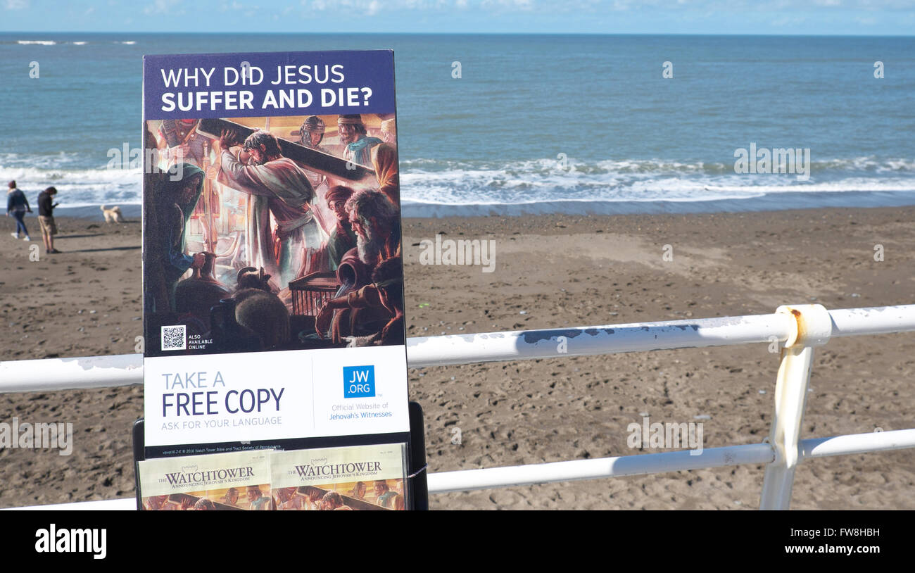 Copies of the Watchtower religious magazine published by Jehovah's Witnesses on promotion at Aberystwyth seafront Wales. Stock Photo