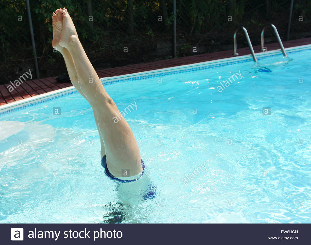 Girl Doing Handstand In Swimming High Resolution Stock Photography and