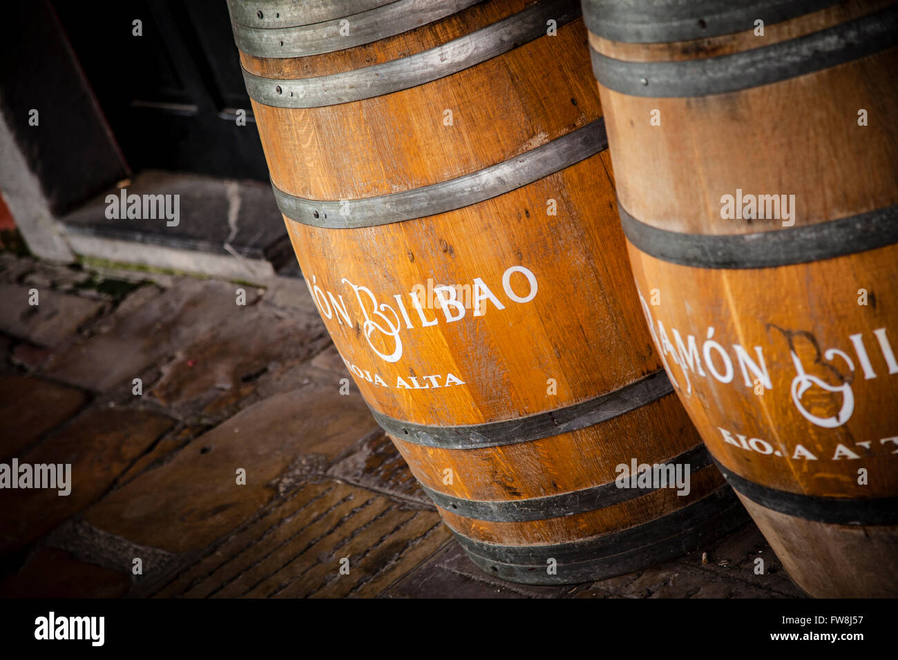 Old oak barrels on the wall background. Stock Photo