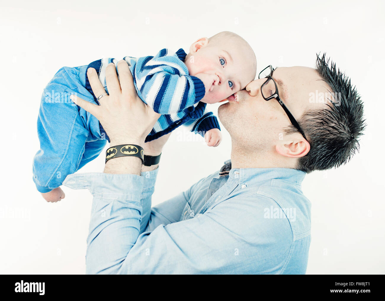 young man holding and kissing his little son Stock Photo