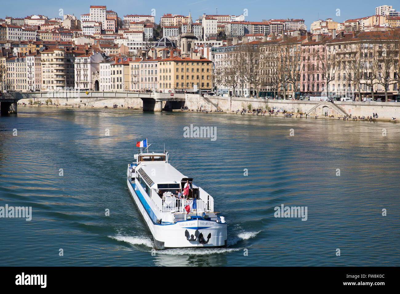 Lyon, France - March 26, 2016: Boat moving down the Saone river in the city of Lyon. Stock Photo
