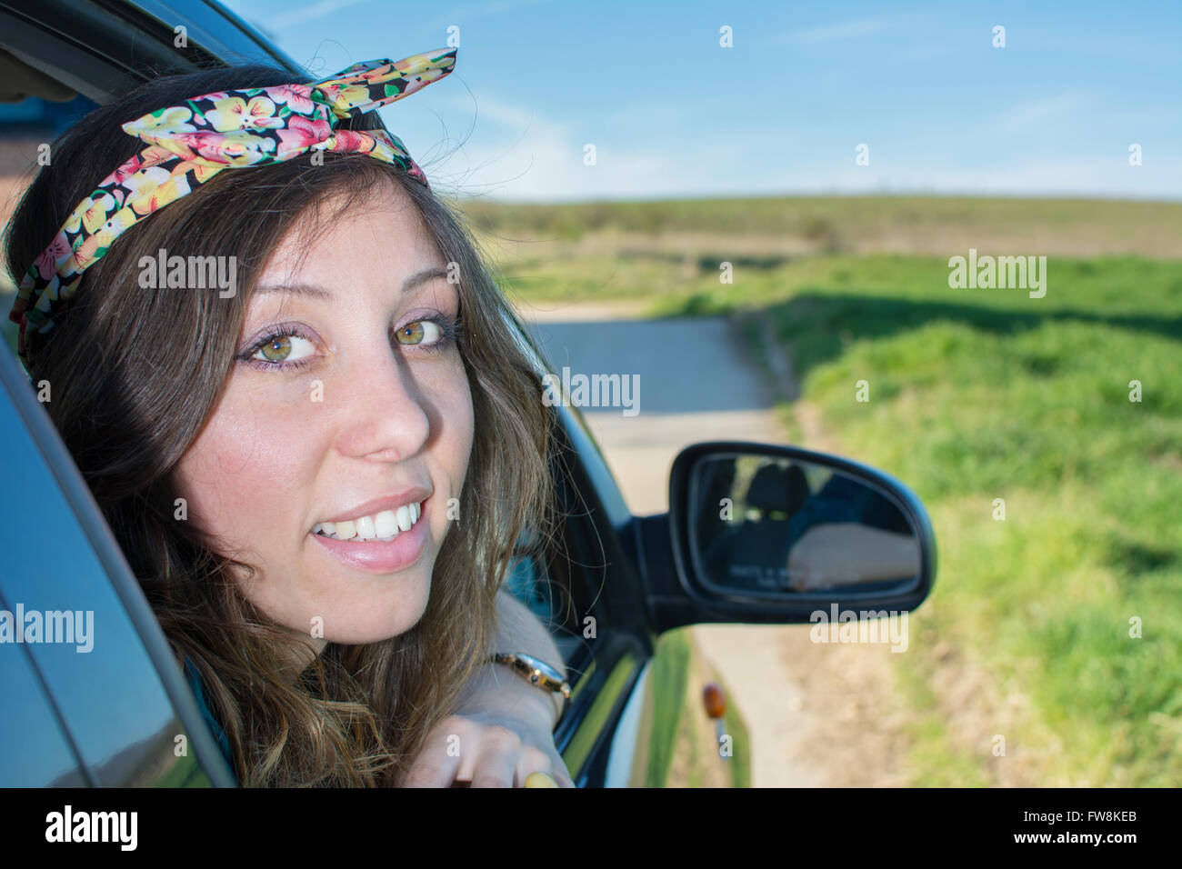 Woman looking thru car window on a road trip Stock Photo